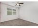 A carpeted bedroom features neutral walls, a ceiling fan, and window with blinds at 7138 W Kent Dr, Chandler, AZ 85226