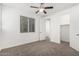 Bright bedroom featuring neutral walls, carpeted floors, ceiling fan and a closet at 7138 W Kent Dr, Chandler, AZ 85226