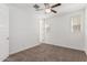 A bedroom featuring carpet floors, ceiling fan, and bright windows with blinds at 7138 W Kent Dr, Chandler, AZ 85226