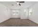 Bright bedroom with neutral carpet, ceiling fan, recessed lighting, and multiple windows for ample natural light at 7138 W Kent Dr, Chandler, AZ 85226