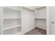 A walk-in closet features built-in shelving and wooden rods for ample storage at 7138 W Kent Dr, Chandler, AZ 85226