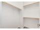 Empty walk-in closet featuring white walls, wooden closet rods, and neutral carpet creating an organized space at 7138 W Kent Dr, Chandler, AZ 85226