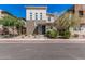 Contemporary home featuring a mix of stone and stucco, a blue front door, and landscaped front yard at 7138 W Kent Dr, Chandler, AZ 85226