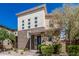 Contemporary two-story home featuring a mix of brick and stucco exterior finishes with manicured landscaping at 7138 W Kent Dr, Chandler, AZ 85226