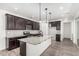 Beautiful kitchen featuring stainless steel appliances, a large island, and dark cabinets with granite countertops at 7138 W Kent Dr, Chandler, AZ 85226