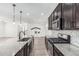 Gourmet kitchen featuring granite counters, stainless appliances, pendant lights and seamless transition to the living space at 7138 W Kent Dr, Chandler, AZ 85226