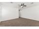 A large, bright main bedroom with carpeted floors, a ceiling fan, and neutral paint at 7138 W Kent Dr, Chandler, AZ 85226