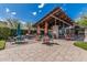 Outdoor community pool area featuring lounge seating, BBQ grills, patio umbrellas and seating under a pergola at 7138 W Kent Dr, Chandler, AZ 85226