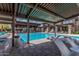 Resort-style pool with plentiful lounge chairs and shade structures on a sunny day at 7138 W Kent Dr, Chandler, AZ 85226