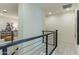 Bright hallway with modern railing and neutral color palette offers a clean and inviting transition between spaces at 7330 E Vista Bonita Dr, Scottsdale, AZ 85255