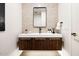 Modern bathroom featuring floating vanity with wood grain, white countertop, decorative backsplash, and square mirror at 7670 E Sierra Vista Dr, Scottsdale, AZ 85250