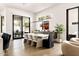 Elegant dining area with hardwood floors, modern lighting, and seamless access to outdoor patio at 7670 E Sierra Vista Dr, Scottsdale, AZ 85250