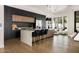 Modern kitchen with a large island, black cabinets, and stainless steel appliances at 7670 E Sierra Vista Dr, Scottsdale, AZ 85250
