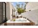 Private outdoor living space with comfortable lounge furniture, travertine patio, and manicured desert landscaping at 7670 E Sierra Vista Dr, Scottsdale, AZ 85250