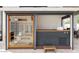 Outdoor spa featuring sauna with glass door, wood accents, hot tub with tile surround, and wood bench at 7670 E Sierra Vista Dr, Scottsdale, AZ 85250