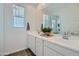 Bright bathroom features a dual vanity with white countertops and modern fixtures at 8259 E Petunia Ave, Mesa, AZ 85212