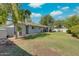 Backyard featuring a covered patio, mature trees, and a large grassy area at 8319 E Indianola Ave, Scottsdale, AZ 85251