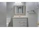 Small bathroom features tiled wall mirror, vanity, toilet and towel rack at 8319 E Indianola Ave, Scottsdale, AZ 85251