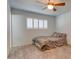 Clean bedroom featuring tile floors, a ceiling fan, and a window with shutters at 8319 E Indianola Ave, Scottsdale, AZ 85251