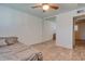 Cozy bedroom featuring wood floors, a ceiling fan, and mirrored closet doors at 8319 E Indianola Ave, Scottsdale, AZ 85251