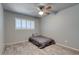 Cozy bedroom featuring a ceiling fan, window with white shutters, and wood-look floors at 8319 E Indianola Ave, Scottsdale, AZ 85251