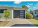 Modern garage door design with sleek windows and a well-kept driveway at 8319 E Indianola Ave, Scottsdale, AZ 85251