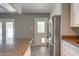 Kitchen featuring granite counters, white cabinets, a stainless steel refrigerator, and a back door at 8319 E Indianola Ave, Scottsdale, AZ 85251