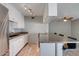 Open kitchen area featuring a breakfast bar, white cabinets, granite counters, and stainless steel refrigerator at 8319 E Indianola Ave, Scottsdale, AZ 85251