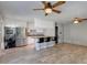 Open concept kitchen with stainless steel appliances, a large counter bar, and warm wood tile flooring at 8319 E Indianola Ave, Scottsdale, AZ 85251
