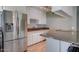 Bright kitchen boasting granite countertops, stainless steel appliances, and a built-in breakfast bar at 8319 E Indianola Ave, Scottsdale, AZ 85251