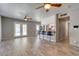 Open concept living room, with tile floor, multiple ceiling fans, connecting to a kitchen area with a breakfast bar at 8319 E Indianola Ave, Scottsdale, AZ 85251