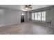 Welcoming living room featuring a bay window with seating, a dark front door, and neutral paint at 8319 E Indianola Ave, Scottsdale, AZ 85251