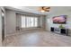 Bright living room with tile floors, ceiling fan, large window bench, and television at 8319 E Indianola Ave, Scottsdale, AZ 85251