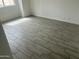 Bedroom featuring tile flooring, white walls and baseboards, and a window at 8349 W Holly St, Phoenix, AZ 85037