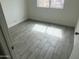 An additional view of the room featuring tile flooring, white walls and baseboards, and a window at 8349 W Holly St, Phoenix, AZ 85037