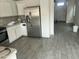 Open concept kitchen with white cabinets, stainless steel appliances and stylish tile flooring at 8349 W Holly St, Phoenix, AZ 85037