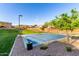 Outdoor community basketball court with a beautiful green lawn and desert landscape in the background at 851 E Deer Creek Rd, Phoenix, AZ 85048