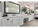Bathroom featuring dual vanities, quartz countertops, modern fixtures, and black framed mirrors at 851 E Deer Creek Rd, Phoenix, AZ 85048