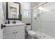 Well-lit bathroom with white vanity, black hardware, and a glass-enclosed shower at 851 E Deer Creek Rd, Phoenix, AZ 85048