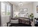 Comfortable bedroom with plantation shutters, modern light fixture, a dark metal bed frame and neutral decor at 851 E Deer Creek Rd, Phoenix, AZ 85048