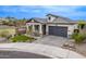 Charming home featuring a gray garage door, stone accents, well-maintained landscaping, and a paver driveway at 851 E Deer Creek Rd, Phoenix, AZ 85048