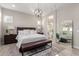 Serene main bedroom featuring a large bed, a sitting area, and ensuite bath access at 851 E Deer Creek Rd, Phoenix, AZ 85048