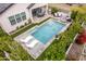 Aerial view of a backyard featuring a pool, lounge chairs, covered patio, and professional landscaping at 851 E Deer Creek Rd, Phoenix, AZ 85048
