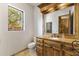 Bathroom with a rustic wood vanity, wooden mirror, and natural light at 10040 E Happy Valley Rd # 479, Scottsdale, AZ 85255