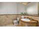 Powder room featuring a carved wood vanity, vessel sink, and decorative wall mirror at 10040 E Happy Valley Rd # 479, Scottsdale, AZ 85255