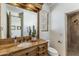 Rustic bathroom features a wood vanity, framed mirror, neutral walls, and walk-in shower at 10040 E Happy Valley Rd # 479, Scottsdale, AZ 85255