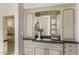 Elegant bathroom vanity with granite countertop, custom cabinets, and decorative mirror at 10040 E Happy Valley Rd # 479, Scottsdale, AZ 85255