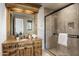 Rustic bathroom featuring wood vanity, stone tiled shower, and neutral color palette at 10040 E Happy Valley Rd # 479, Scottsdale, AZ 85255