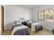 Bright bedroom with two twin beds, a desert view, and neutral decor at 10040 E Happy Valley Rd # 479, Scottsdale, AZ 85255