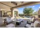 Spacious covered patio overlooking the pool area, complete with a fireplace and seating at 10040 E Happy Valley Rd # 479, Scottsdale, AZ 85255